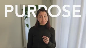 YouTube thumbnail of Michél Lipan speaking on camera, with bold overlay text “Purpose”.